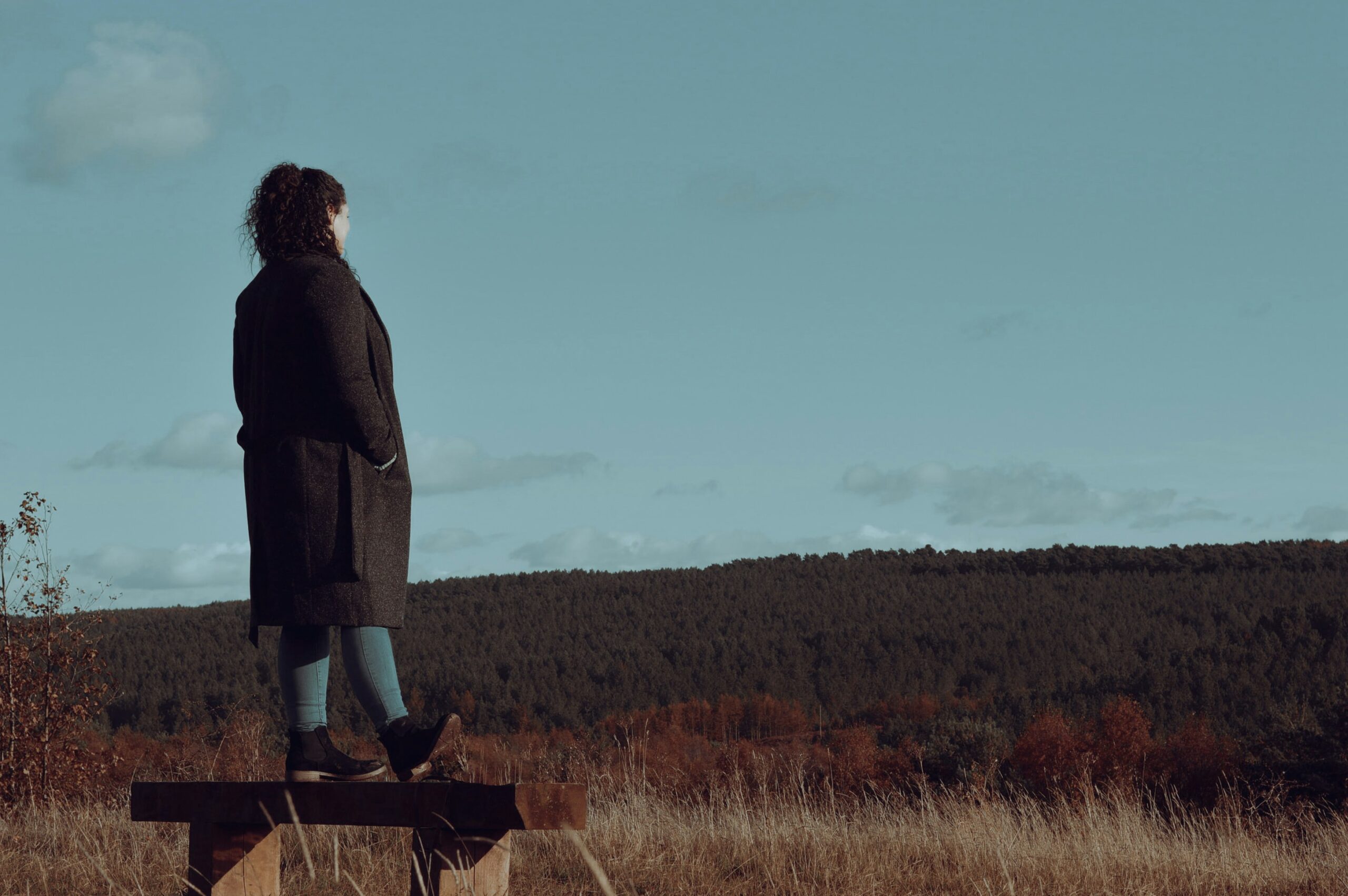 woman outdoors reflecting on her signs of personal growth