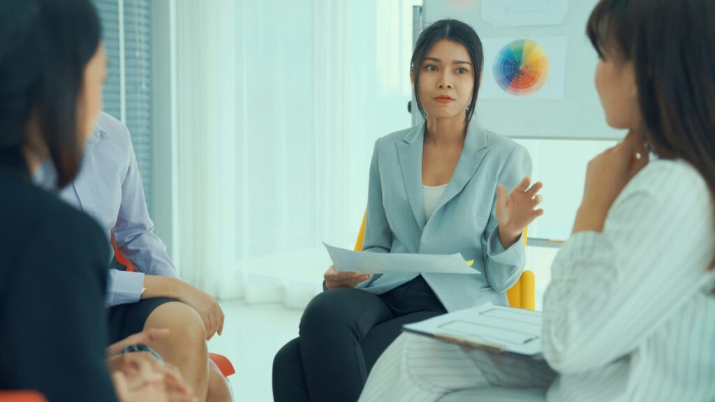 a stable leader speaking with her team in an office