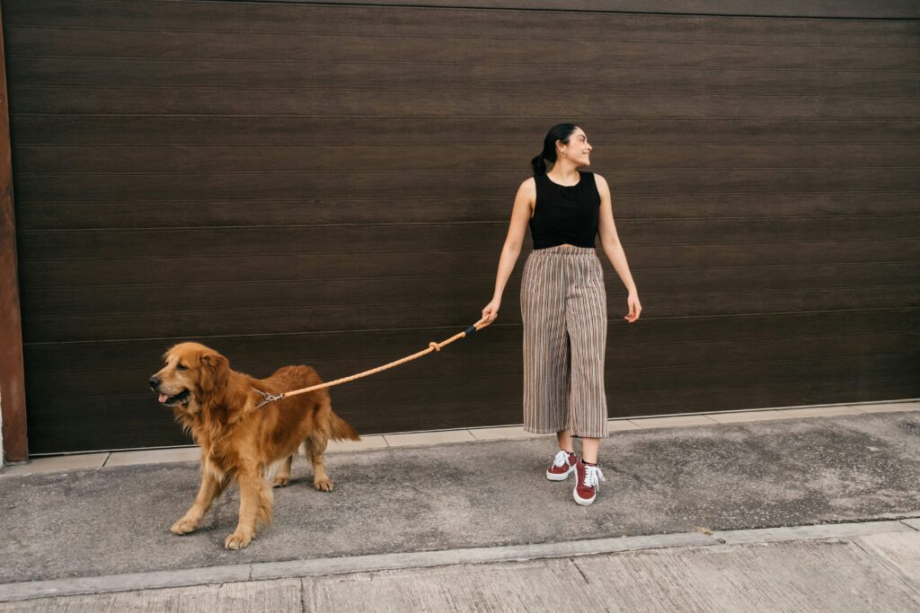 happy woman enjoying walking her dog outside