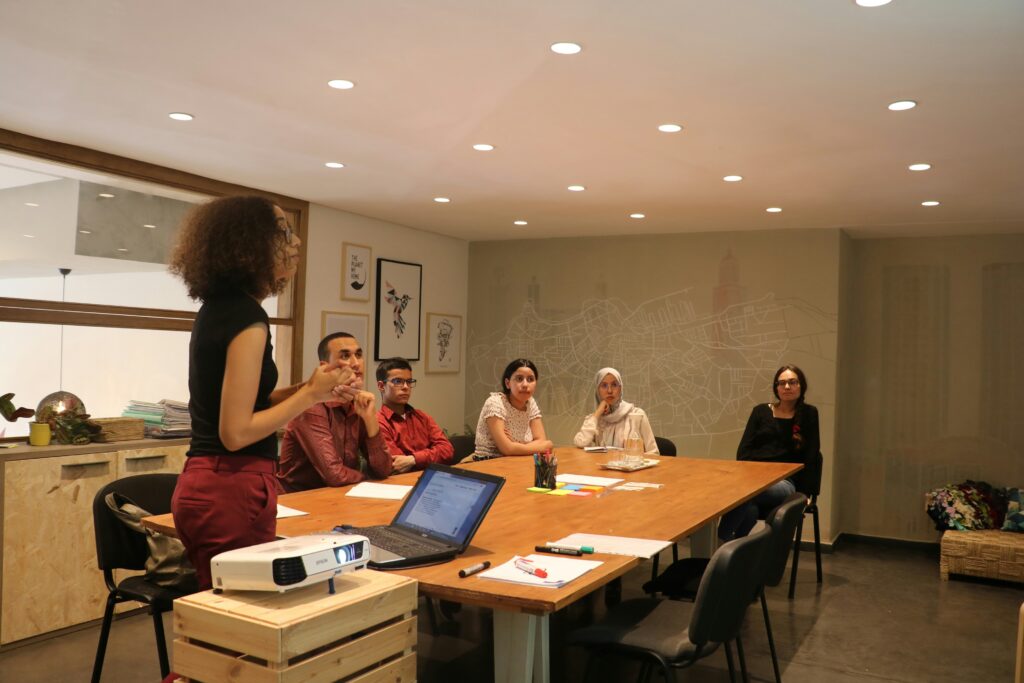 woman leading a team in corporate meeting